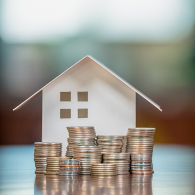 Home with cents stacked up. Equity.